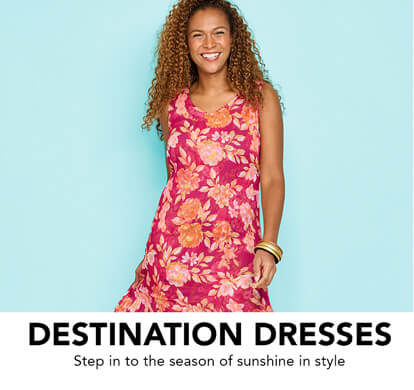 A female model, smiling, conducting a twirl in her floral pattern summer dress.